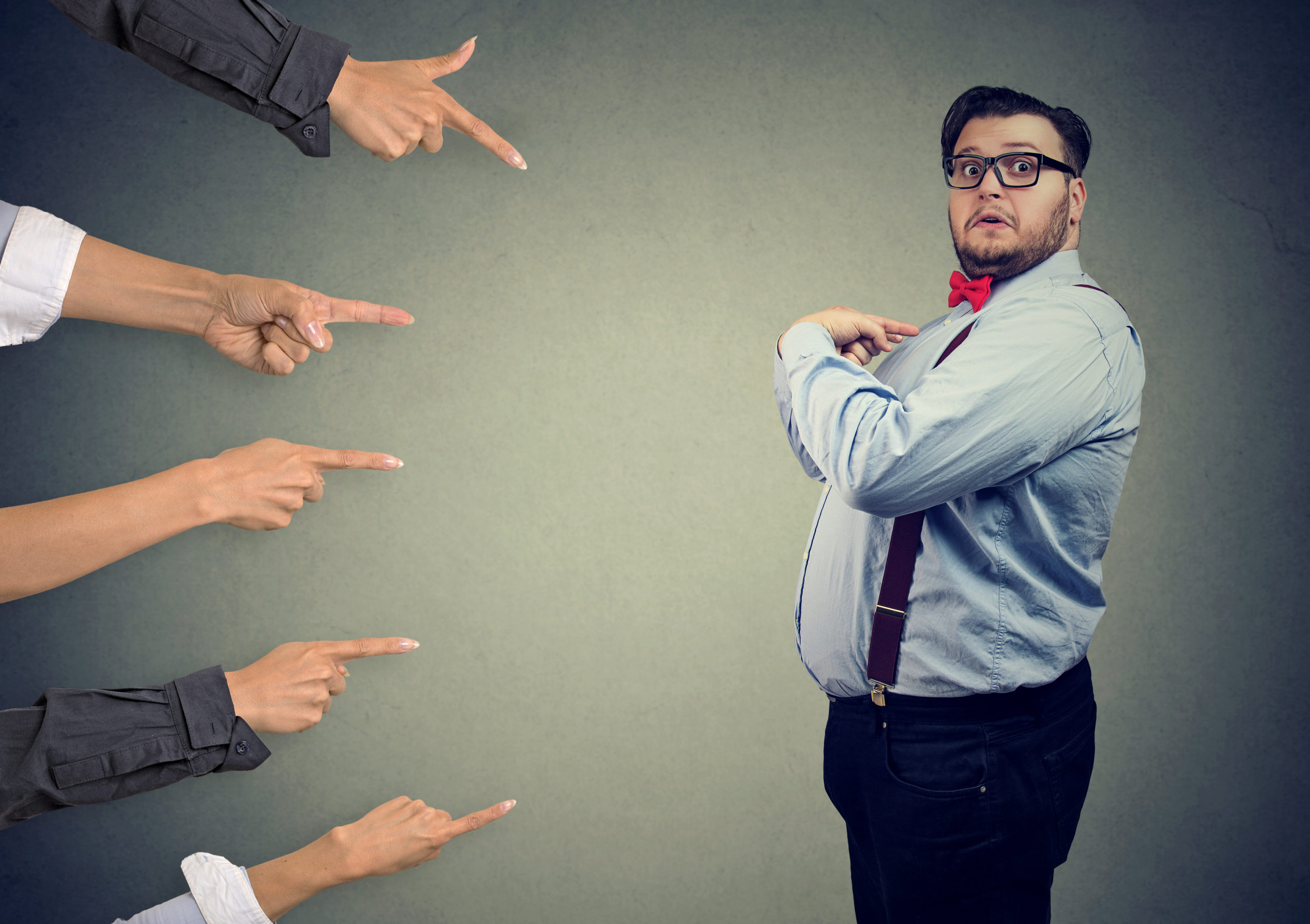 Blaming you. Anxious surprised business man judged by different people pointing fingers at him. Accusation of guilty guy.